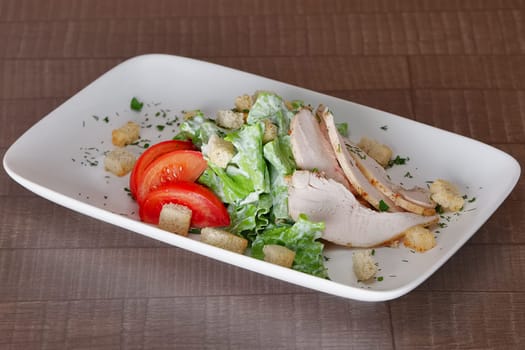 Vegetable salad with fried chicken meat. Greek salad.