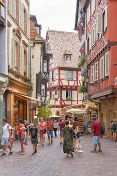 Tourists from all over the world in the picturesque medieval old town of Colmar in France