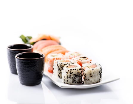 Closeup of traditional japanese sushi set with salmon and tuna fish isolated on white background. Sushi bar menu design with copyspace.