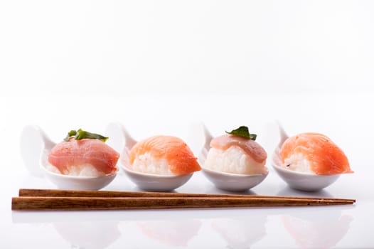 Closeup of traditional japanese sushi set with salmon and tuna fish isolated on white background. Sushi bar menu design with copyspace.