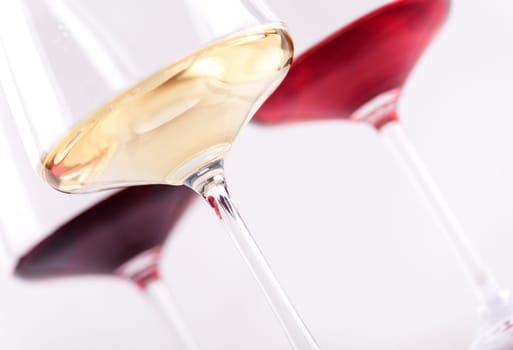 Closeup of three glass of red, rose and white wine isolated over white background. Wine list menu design with copyspace.