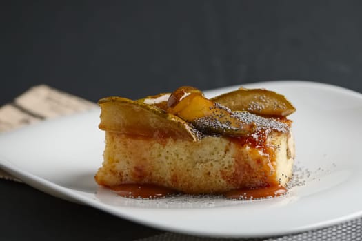 Piece of pear pie with poppy and sauce.