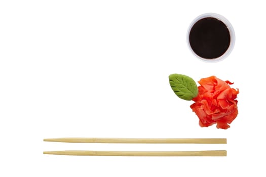 Flat layout - chopsticks, wasabi, pickled ginger and soy sauce isolated on white background. Photo with clipping path.