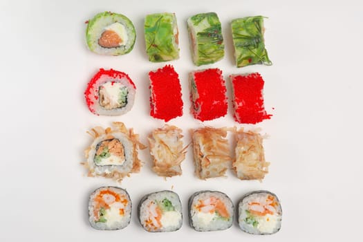Set of rolls with smoked salmon, eel, chuka salad and flying fish roe on white background. Top view.