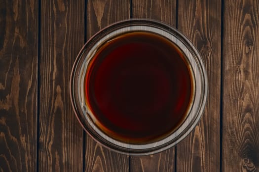 Top view of plate with soy sauce on wooden table