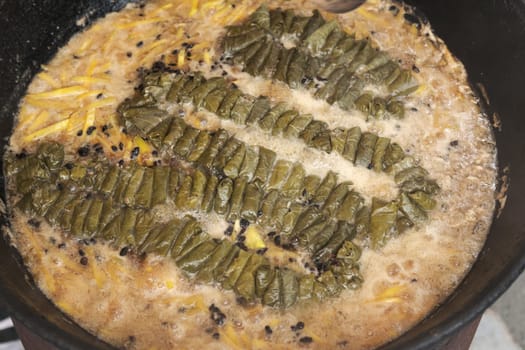 Meat and dolma in cauldron. The making of pilaf, step by step.