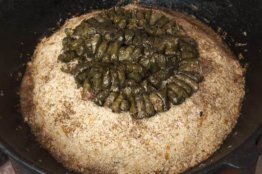 Meat and dolma in cauldron. The making of pilaf, step by step.