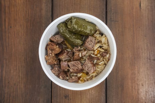 Soft focus photo of dolma and fried meat in take away plate