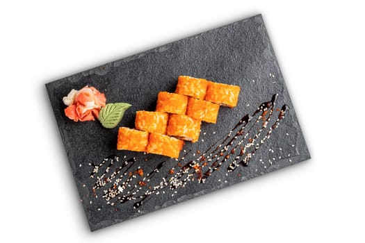 Set of rolls with wasabi and pickled ginger on stone serving board isolated on white