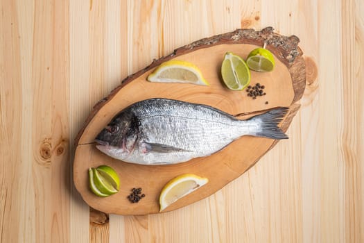 Fresh raw dorada on wooden cutting board