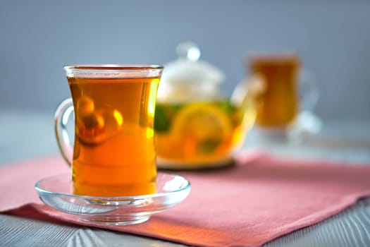 Selective focus photo of citrus tea with lemon, orange and mint