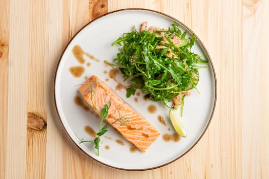 Steamed salmon with arugula and shrimps garnish