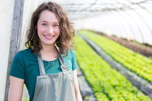VIew of an attractive farmer in a greenhouse