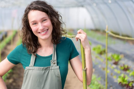View of an attractive farmer in a greenhouse