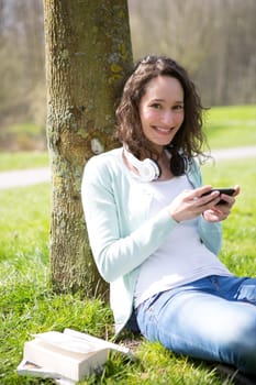 View of a Young attractive woman realxing at the park