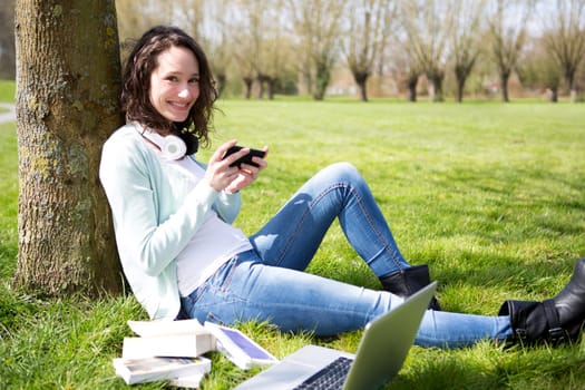 View of a Young attractive woman realxing at the park