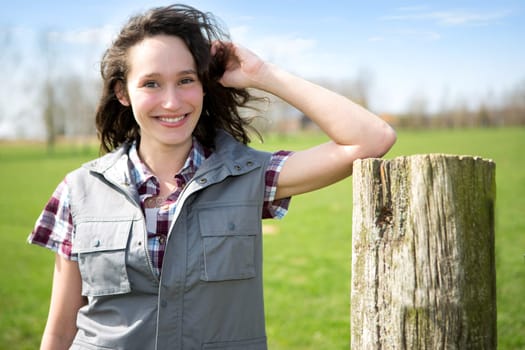 View of a young attractive farmer in fields