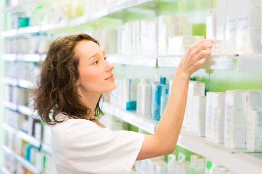 VIew of an Attractive pharmacist clean the store up