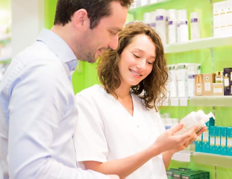 VIew of an Attractive pharmacist advising a patient