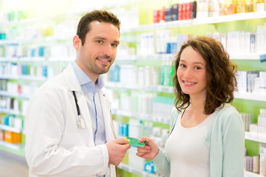 VIew of an Attractive pharmacist advising a patient