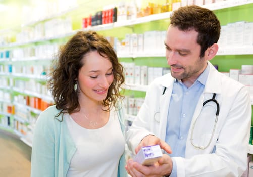 VIew of an Attractive pharmacist advising a patient