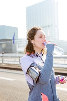 View of a Woman drinking water during a running session