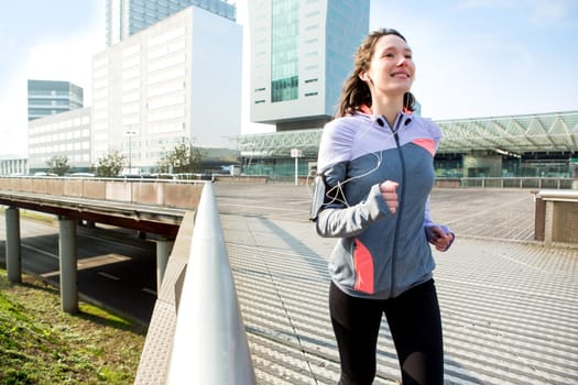 View of a Young attractive woman running downtown