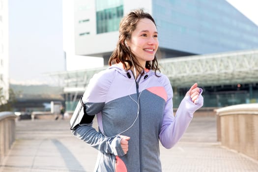 View of a Young attractive woman running downtown