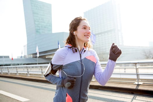 View of a Young attractive woman running downtown