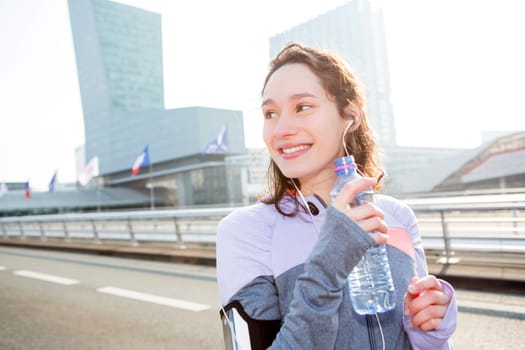 View of a Woman drinking water during a running session