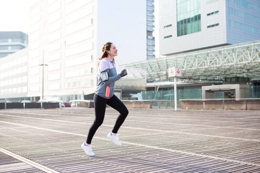 View of a Young attractive woman running downtown