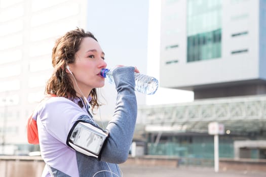 View of a Woman drinking water during a running session