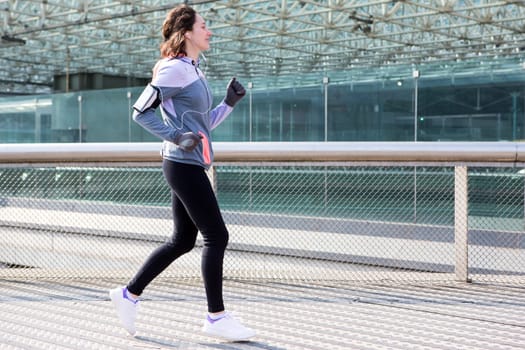 View of a Young attractive woman running downtown
