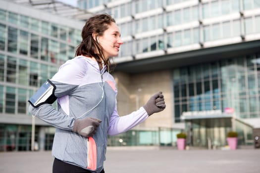 View of a Young attractive woman running downtown