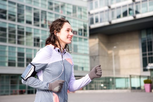 View of a Young attractive woman running downtown