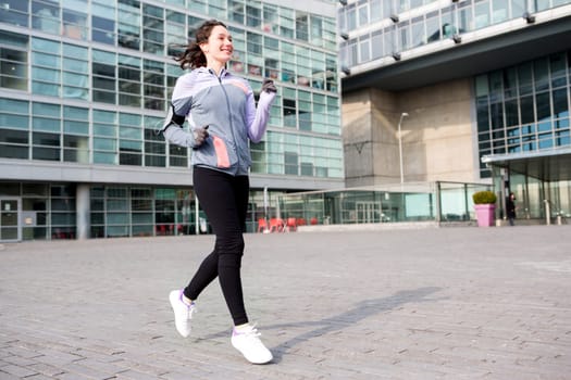 View of a Young attractive woman running downtown