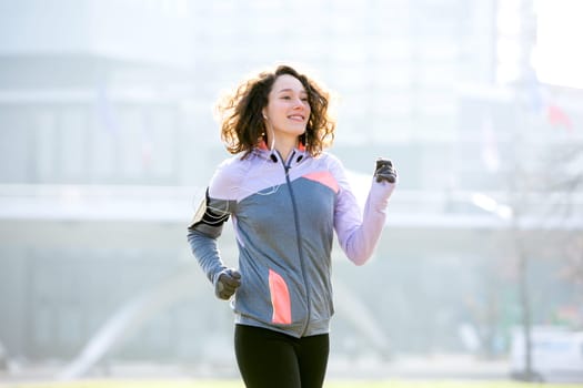 View of a Young attractive woman running at the park