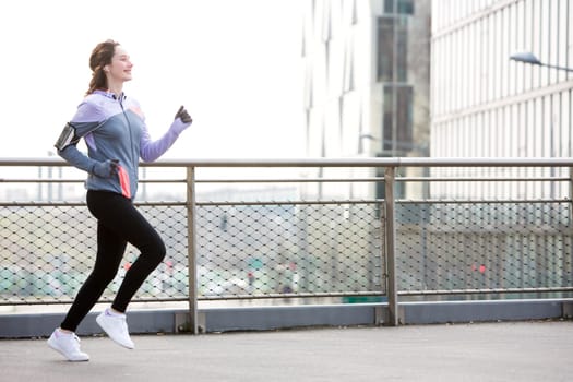 View of a Young attractive woman running downtown