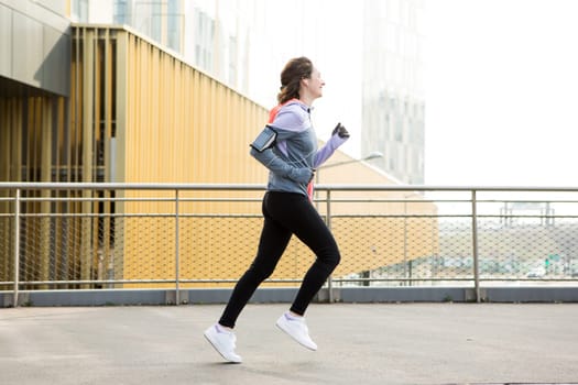 View of a Young attractive woman running downtown
