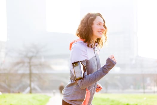 View of a Young attractive woman running at the park