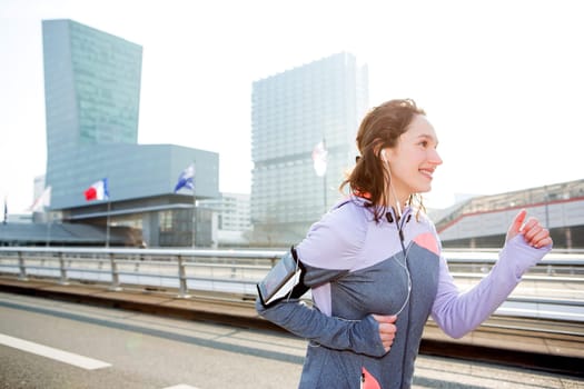View of a Young attractive woman running downtown