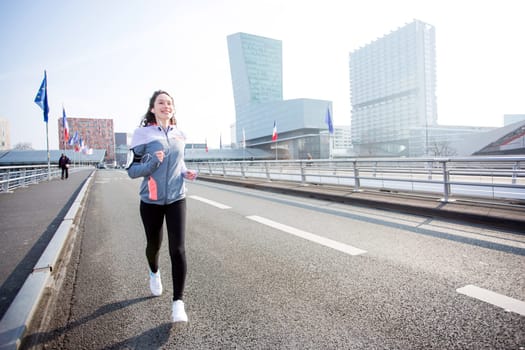 View of a Young attractive woman running downtown