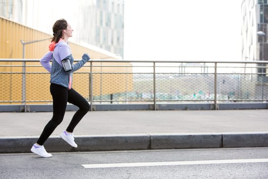 View of a Young attractive woman running downtown