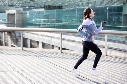 View of a Young attractive woman running downtown