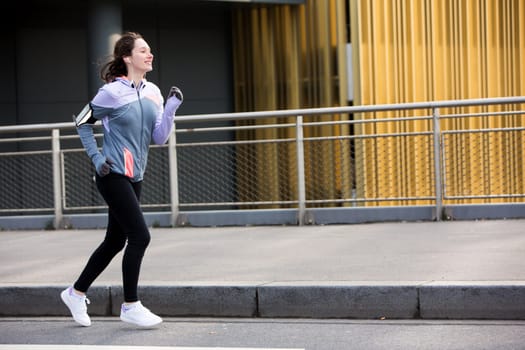 View of a Young attractive woman running downtown