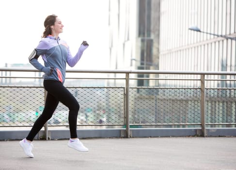 View of a Young attractive woman running downtown