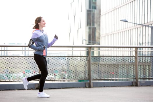 View of a Young attractive woman running downtown