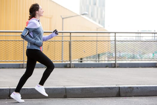View of a Young attractive woman running downtown