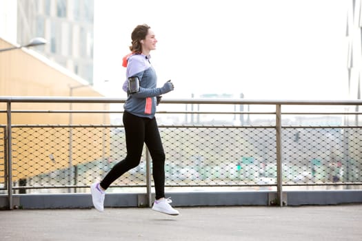 View of a Young attractive woman running downtown