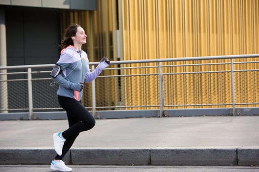View of a Young attractive woman running downtown